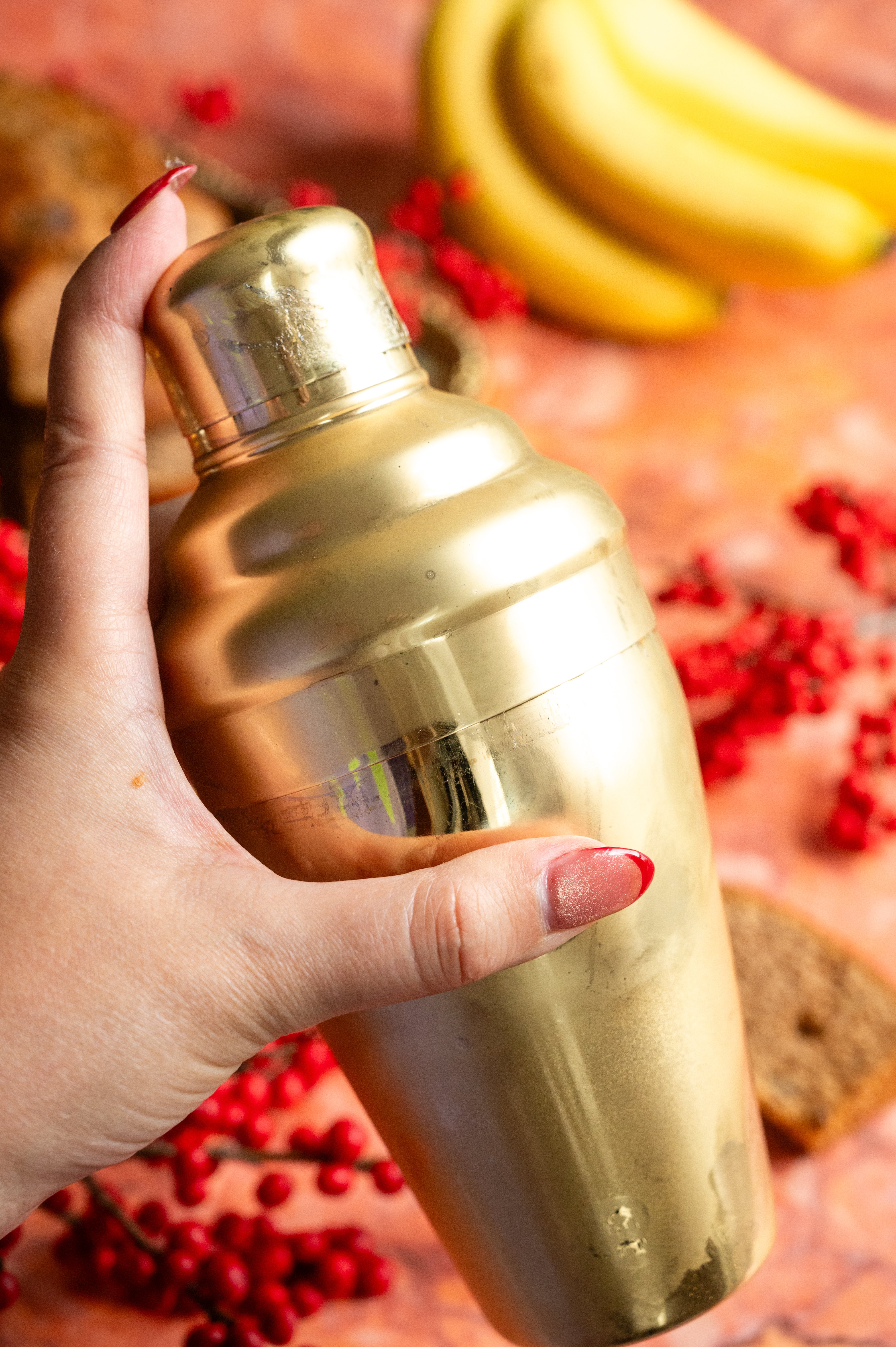 The shaker. has been picked up and is being shaken.