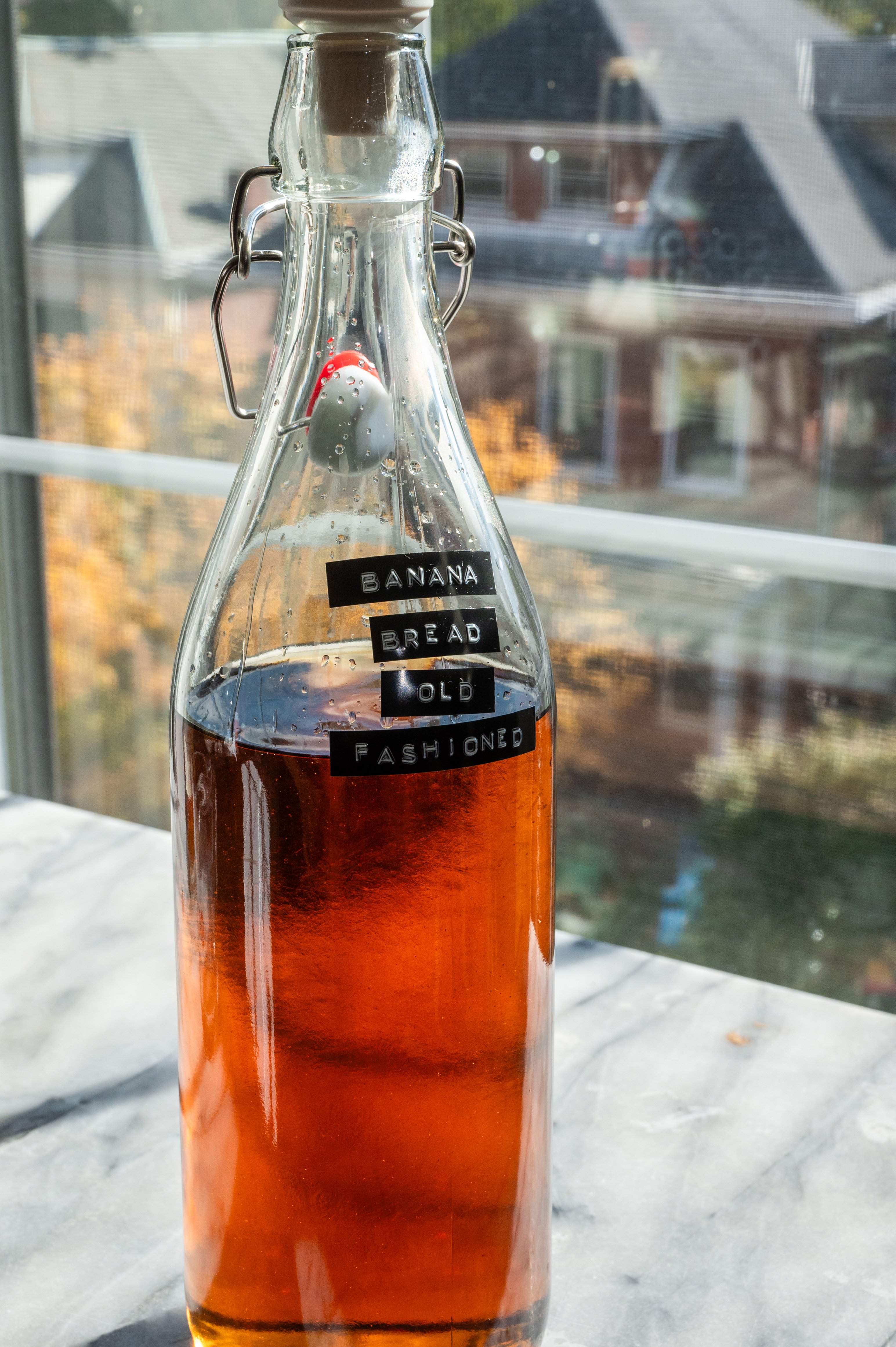 The brown sugar syrup and banana liqueur have been added to the container.