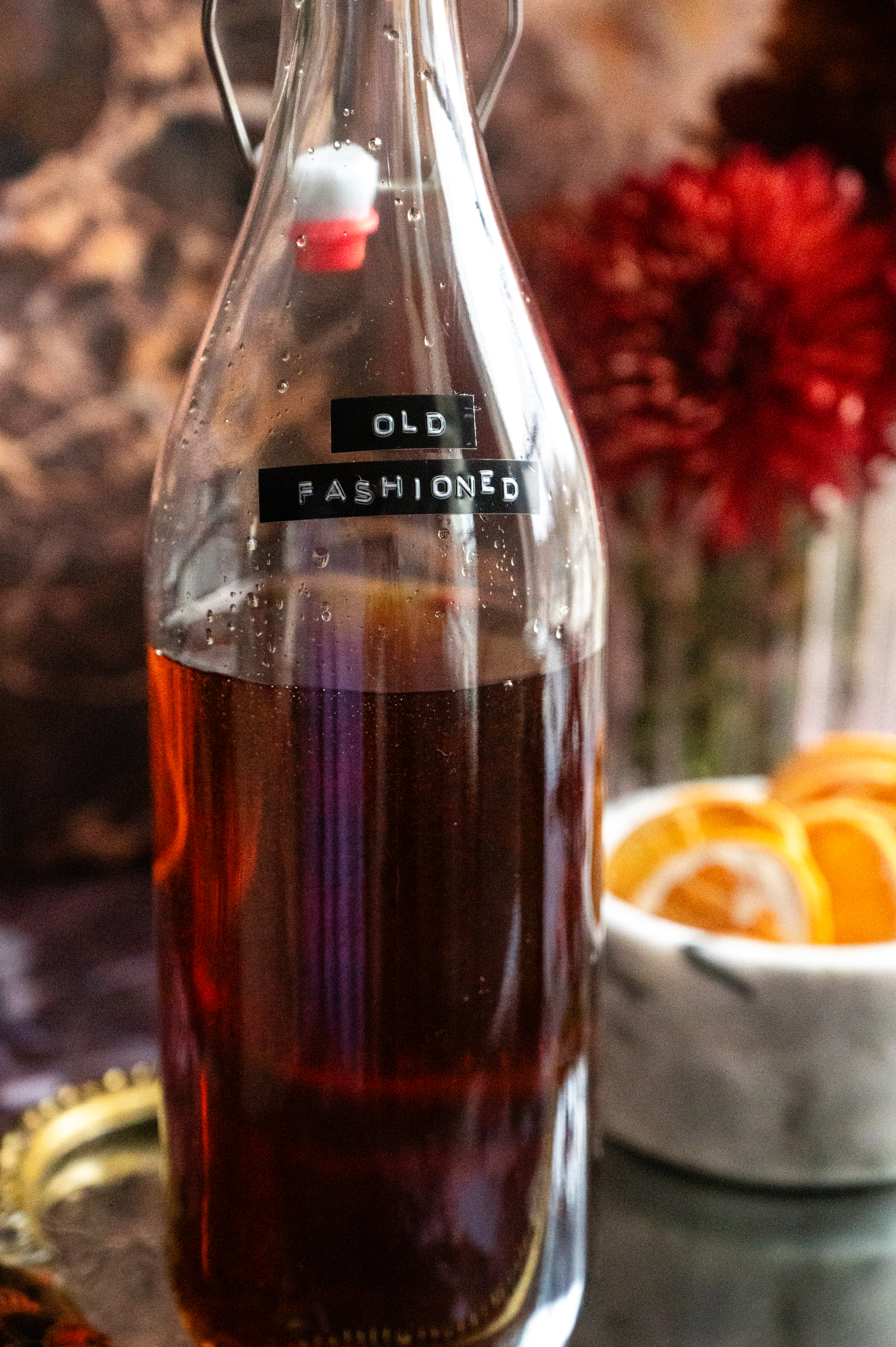 The bourbon sitting in a 32 ounce glass bottle with a label that says old fashioned,