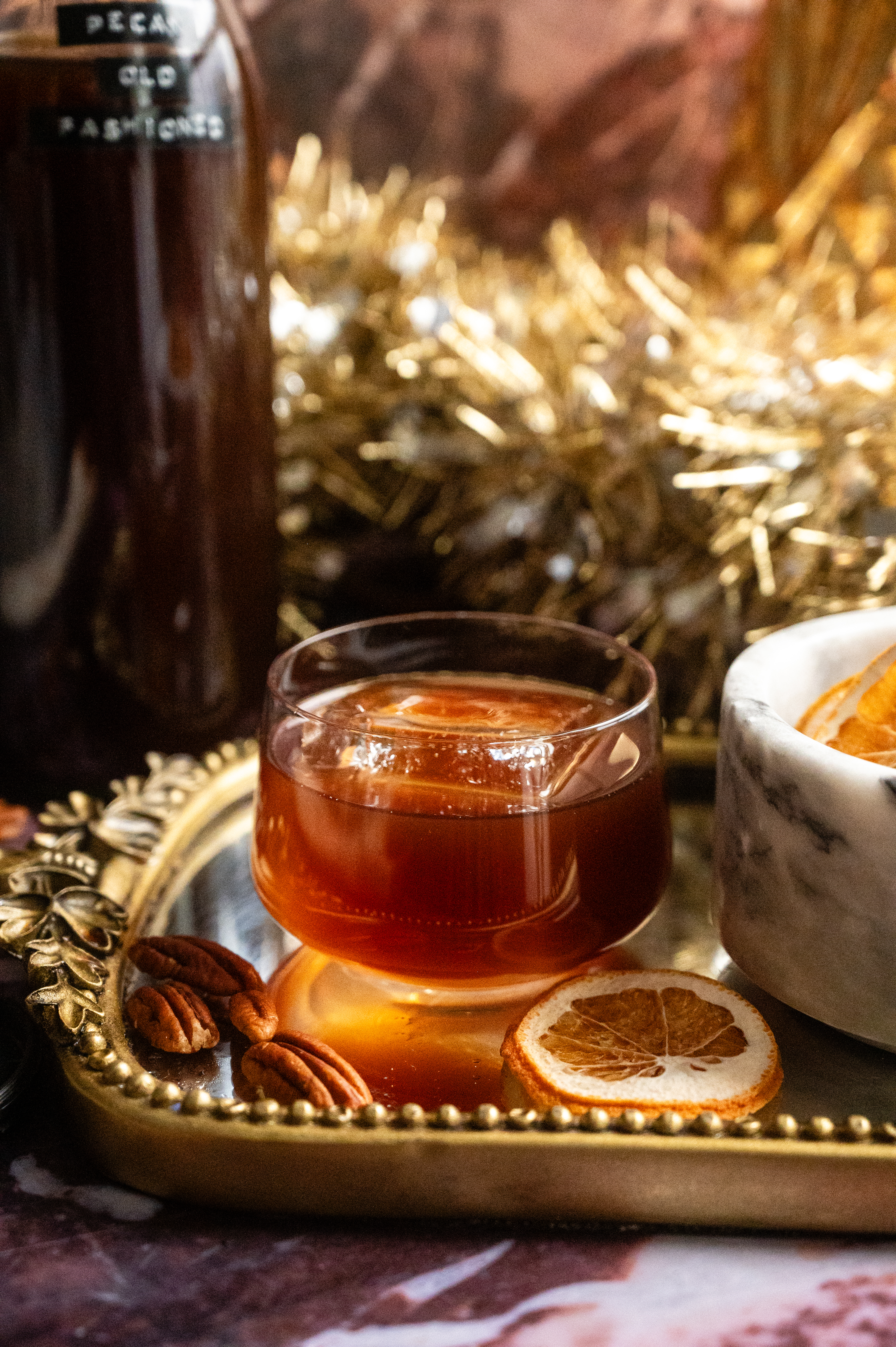 The finished cocktail poured into a glass with 1 large ice cube.