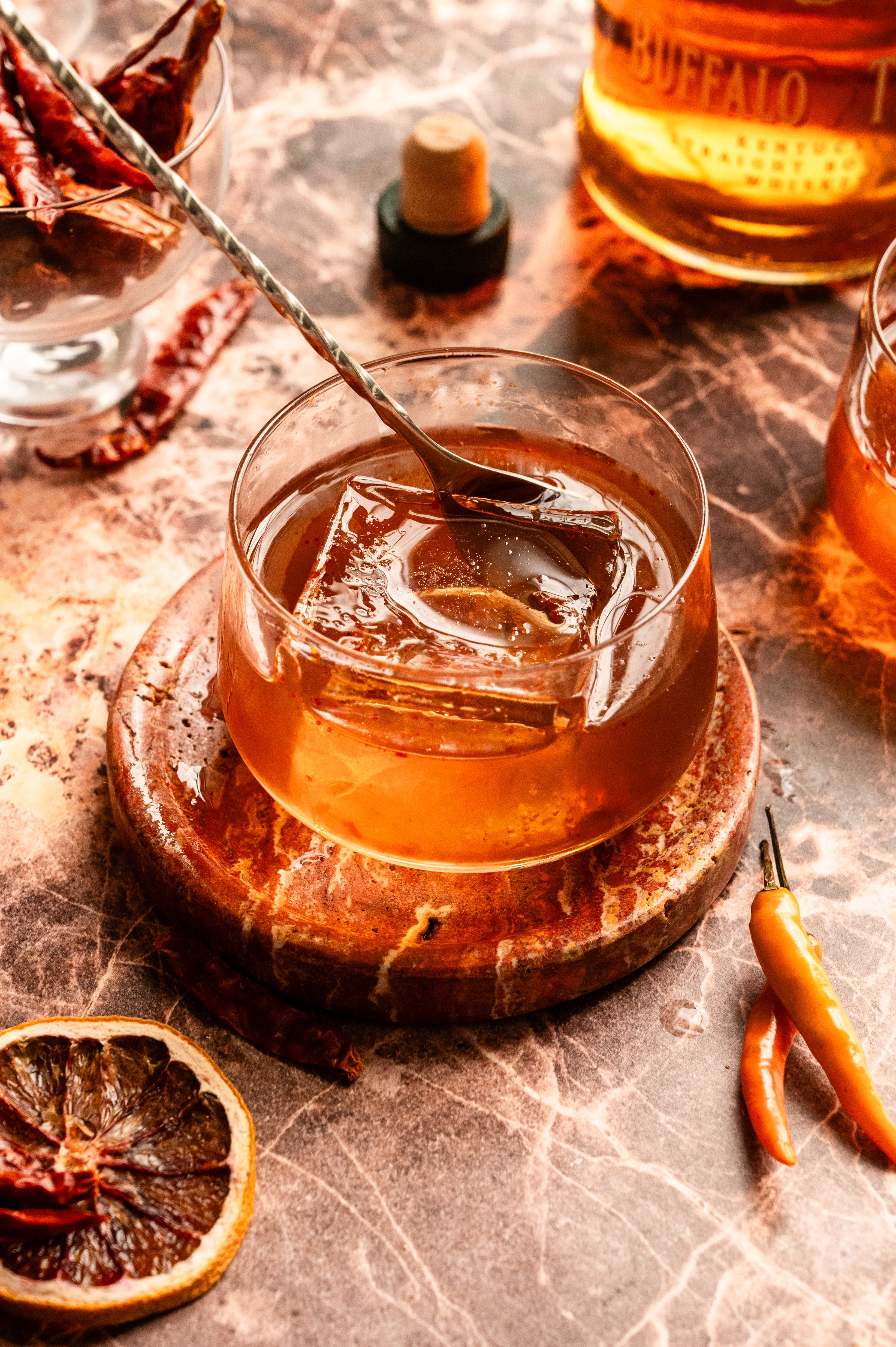 A cocktail stirrer is swirling the drink.