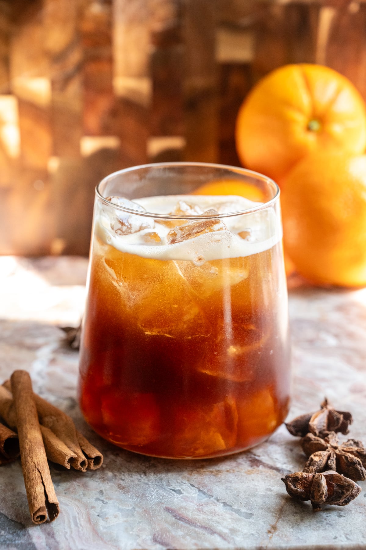 The carajillo has been poured into a rocks glass with ice.