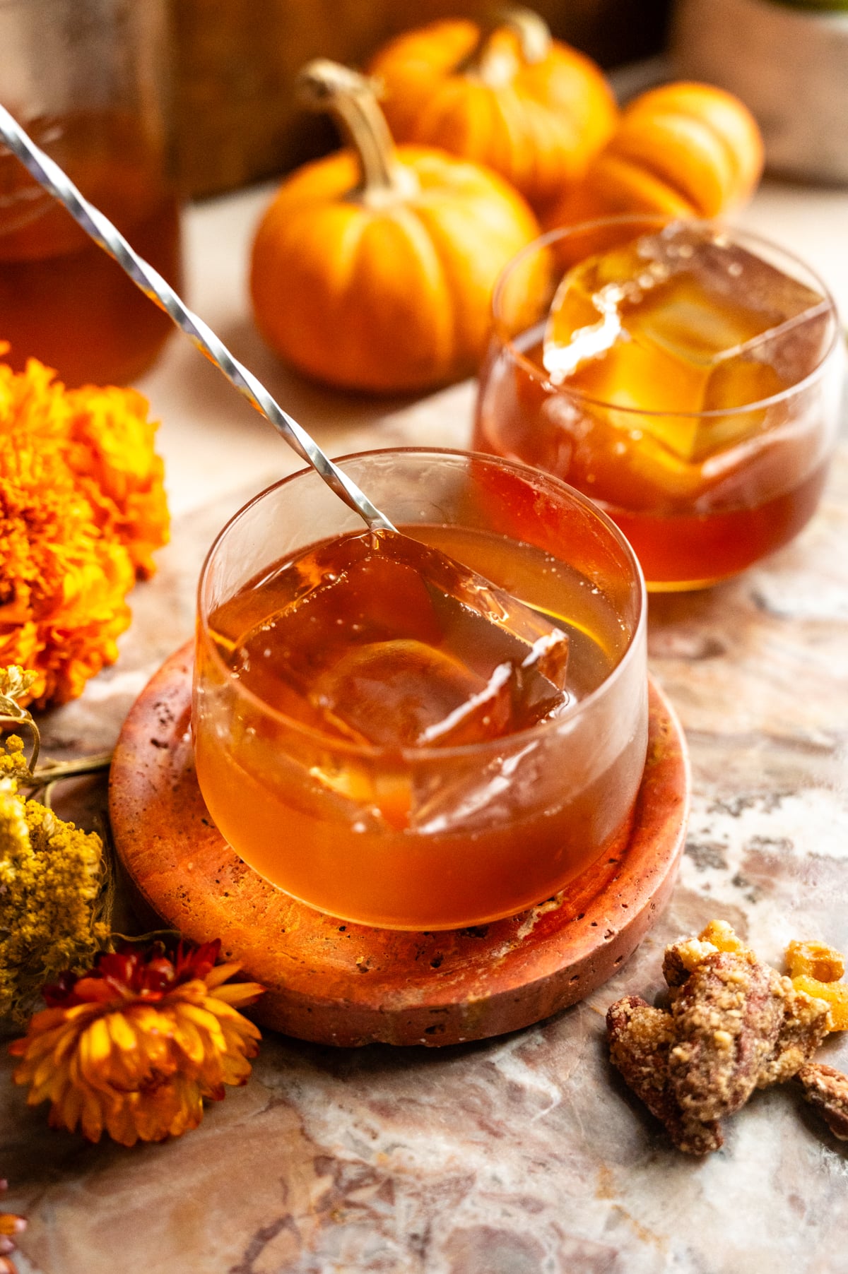 The cocktail is being stirred with a bar spoon.