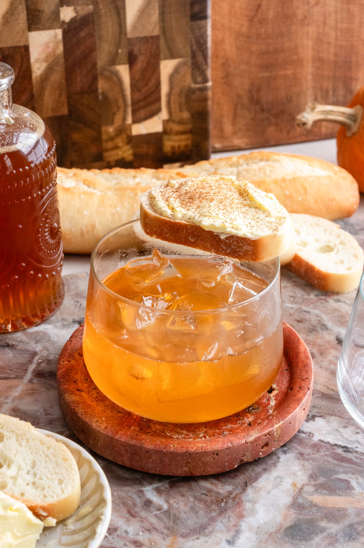 Honey butter old fashioned with a little slice of bread and butter on top of the drink.