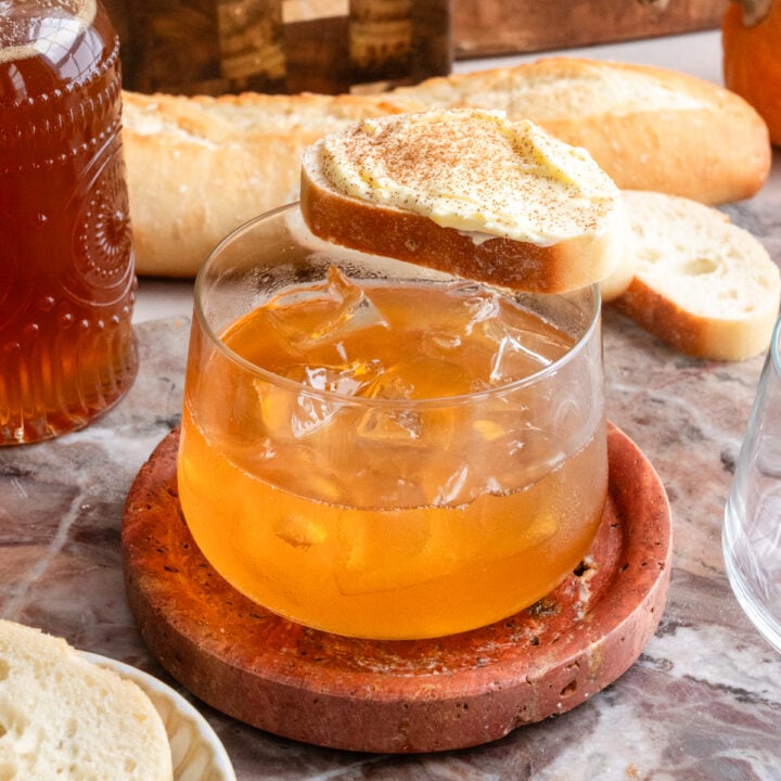 Honey butter old fashioned with a little slice of bread and butter on top of the drink.